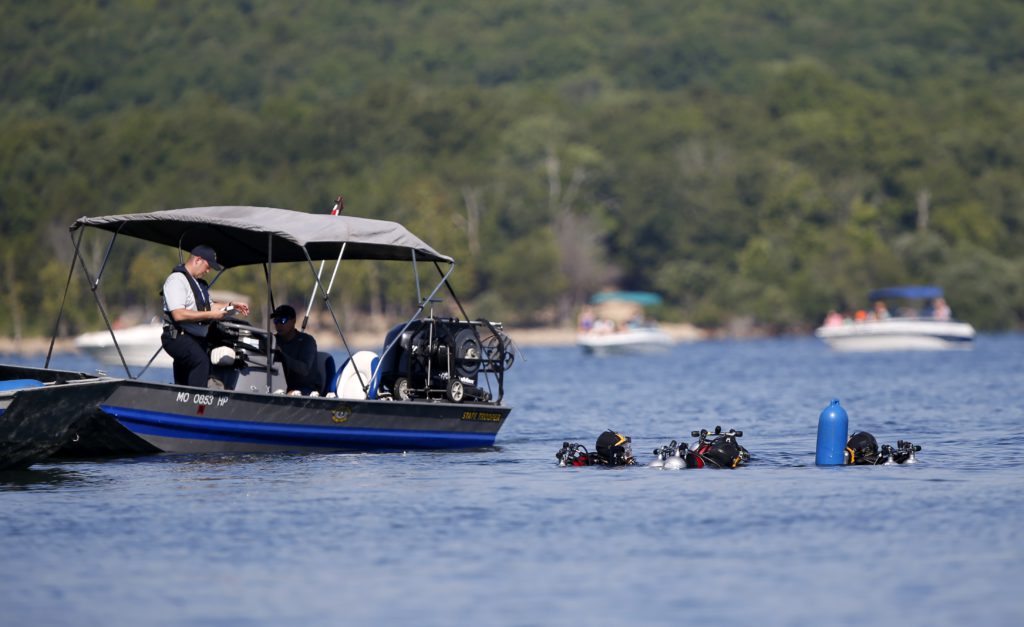 Photo of divers going to retrieve the duck boat that sank in Branson, Mo.